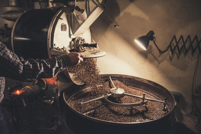 Person brewing coffee with a reusable filter beside a compost container and glass storage jar.